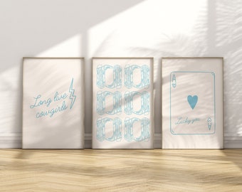 May include: Three framed prints with a white background and blue text and designs. The left print says "Long live cowgirls" with a lightning bolt. The middle print has a pattern of nine blue cowboy boots. The right print has a blue ace of hearts playing card with the text "Lucky you".