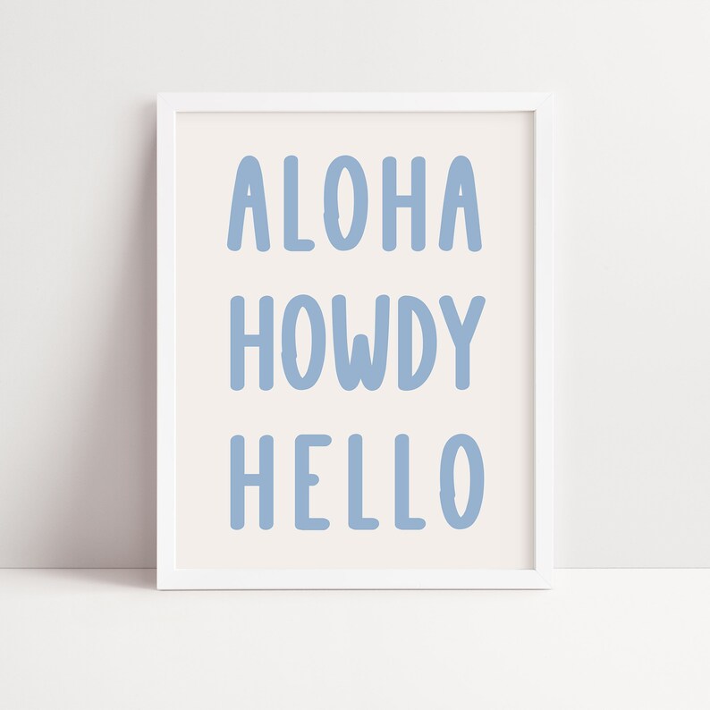 May include: White framed print with the text "ALOHA HOWDY HELLO" in light blue.