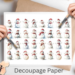 May include: Decoupage paper featuring a repeating pattern of watercolor snowmen. Each snowman wears a red hat and scarf. The paper has the text "Decoupage Paper" at the bottom. The Pixie Decoupage logo is in the lower left corner.