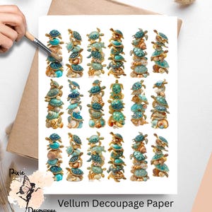 May include: Vellum decoupage paper featuring stacks of turtles in shades of teal, turquoise, and gold. The turtles are arranged on a white background, with a hand holding a paintbrush in the upper left corner. The paper is on a brown surface.