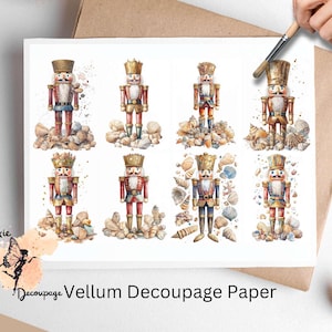 May include: Eight watercolor illustrations of nutcracker figurines with gold accents, each standing on a pile of seashells. The nutcrackers are wearing red, blue, and gold uniforms. The text "Vellum Decoupage Paper" is at the bottom of the image.