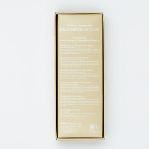 May include: A gold box with a white label that reads "Palo Santo Incense" and "Morning Star". The label also includes the text "A daily source of Tranquility & Serenity" and "Fragrance of Sacred Palo Santo" in English, French, Spanish, German, Italian, and Japanese.