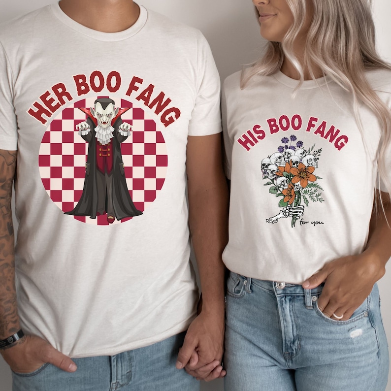 May include: Two white t-shirts with a red and white checkered background. One shirt says "Her Boo Fang" with a cartoon vampire. The other shirt says "His Boo Fang" with a bouquet of skulls and flowers.
