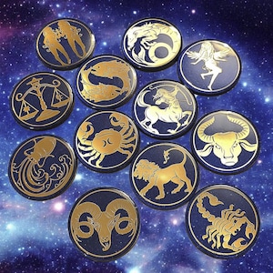 May include: A set of twelve circular, dark blue zodiac sign medallions with gold embossed designs. Each medallion features a different astrological symbol, such as a crab, lion, and scorpion. The background has a starry, galaxy-like pattern.