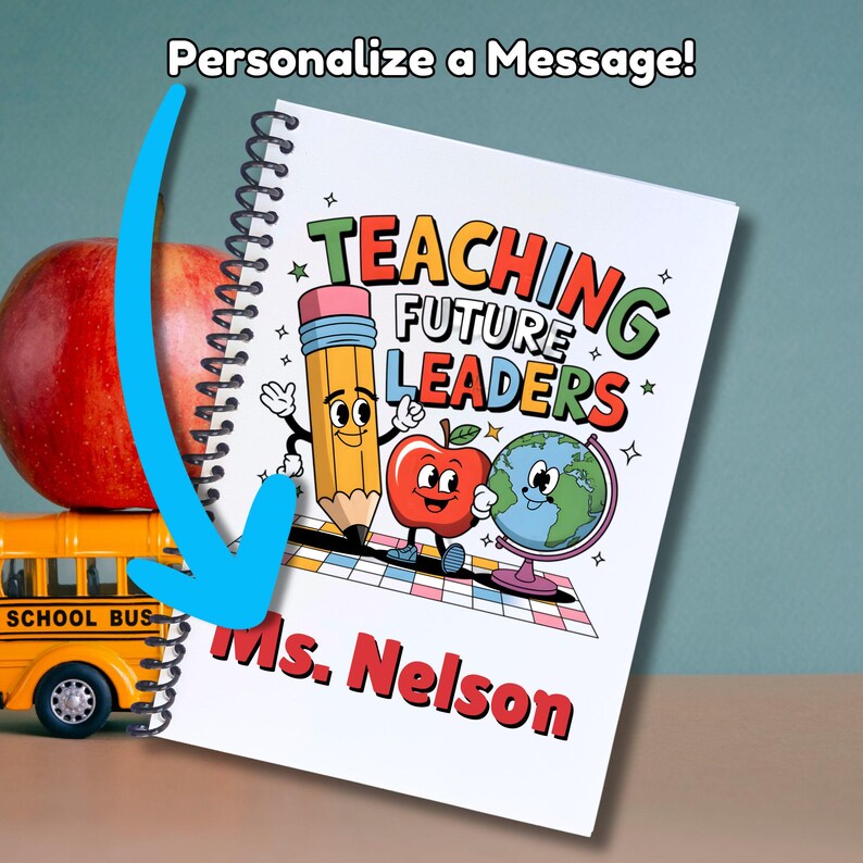 May include: A white spiral notebook with a colorful illustration of a pencil, apple, and globe. The text "Teaching Future Leaders" is in a colorful retro font. The notebook is personalized with the name "Ms. Nelson".