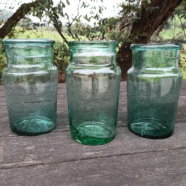 Anciens bocaux en verre vert soufflé. Bocaux ou flacons anciens en verre vert soufflé. Anciens pots ou bocaux en verre soufflé vert.