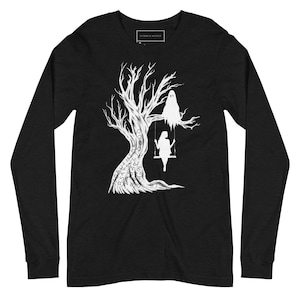 May include: Black long-sleeve t-shirt with a white silhouette of a tree with a ghost and a person on a swing. The tree trunk is covered in words.