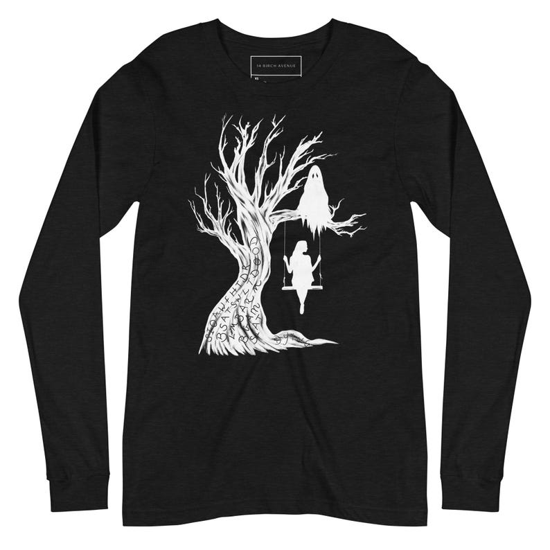 May include: Black long-sleeve t-shirt with a white silhouette of a tree with a ghost and a person on a swing. The tree trunk is covered in words.
