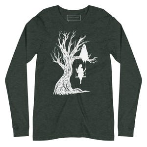 May include: A dark green long-sleeve t-shirt with a white silhouette of a tree with a ghost and a person on a swing. The tree is covered in white text.
