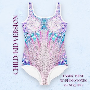 May include: White swimsuit with a colorful mermaid tail print. The print features a sparkly, iridescent design with shades of pink, blue, and purple. The swimsuit has a scoop neck and a racerback style. "FABRIC PRINT NO RHINESTONES OR SEQUINS" is printed on the bottom right corner of the image.