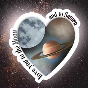 May include: A heart-shaped sticker with a galaxy background and a quote that reads "Love you to the Moon and to Saturn". The sticker features a crescent moon, Saturn with its rings, and a starry sky.