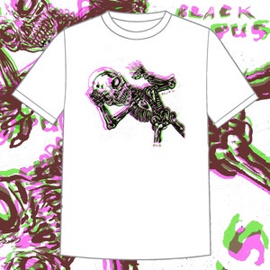 May include: White t-shirt featuring a graphic print of a skeleton in a green and pink colour scheme. The skeleton is holding its head in its hands and has the word "BLACK" written on its chest.
