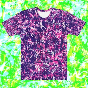 May include: A purple, pink and white t-shirt with a graphic print of abstract shapes and lines.