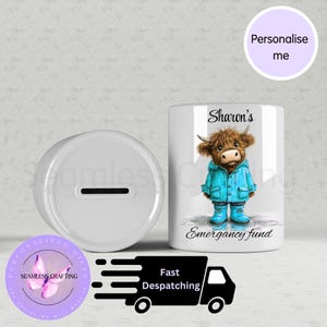 May include: A white ceramic money box and a matching mug. The mug features a cartoon Highland cow in a blue coat and boots, with the text "Sharon's Emergency fund". The money box has a slot for inserting coins.