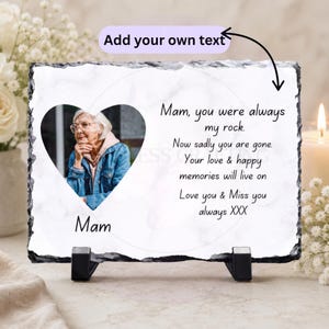 May include: A rectangular slate plaque with a heart-shaped photo of an elderly woman wearing glasses and a denim jacket. The plaque has the text "Mam, you were always my rock. Now sadly you are gone. Your love & happy memories will live on. Love you & Miss you always XXX."