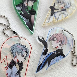 May include: Four heart-shaped acrylic keychains with anime-style character illustrations. Each keychain features a different character in various poses and colors, with a ball chain for attachment. The keychains have a pearlescent finish.