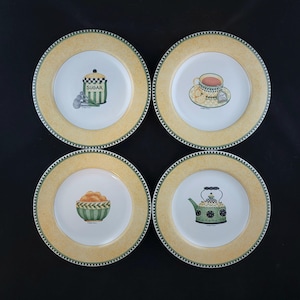 May include: Four decorative plates with a yellow border and a green and white checkered rim. Each plate features a different illustration: a sugar jar, a teacup, a bowl of fruit, and a teapot. The plates have a classic, vintage aesthetic.
