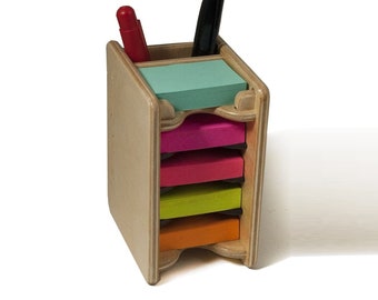 May include: Wooden desk organizer with five compartments for sticky notes. The organizer is made of light wood and has a natural finish. The compartments are filled with colorful sticky notes in shades of green, pink, red, yellow, and orange.