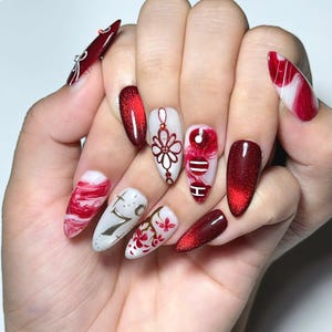 Handmade K-pop concert inspired press on nails featuring burgundy chrome gradients, glossy marble nail art, elegant floral details, concertcore aesthetic, and luxury reusable gel nails perfect for concerts, fan meetings, and music festivals.