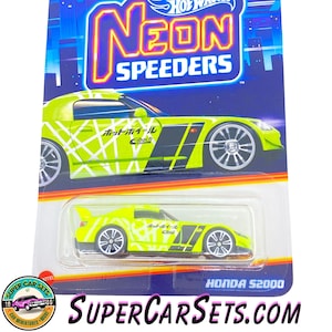 May include: A yellow Hot Wheels Neon Speeders die-cast toy car with black and white details. The car is a Honda S2000. The packaging has the Hot Wheels logo and the words "Neon Speeders".