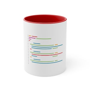 Può includere: Tazza in ceramica bianca con bordo rosso. La tazza presenta un design di linee colorate che ricordano il codice sulla parte anteriore.