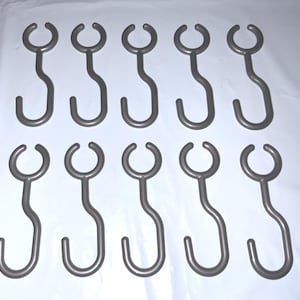 May include: A set of ten gray metal shower curtain hooks. Each hook has a curved, open top and a curved, S-shaped body. The hooks are arranged in two rows of five against a white background.