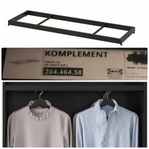 May include: Black metal shelf frame with the text "KOMPLEMENT 100x35 cm (39 3/8x13 3/4)" and the price "204.464.58".