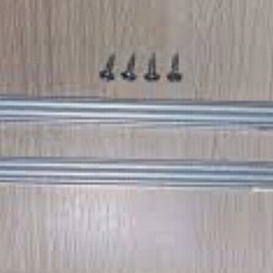 May include: Two silver metal support bars with mounting holes and four screws are displayed on a light brown wooden surface. The bars are long and rectangular, with a series of parallel lines running along their length.
