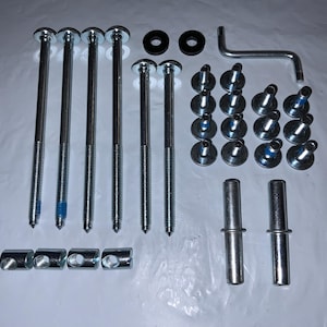 May include: A hardware kit with various metal fasteners, including long bolts, washers, screws, and dowels. The bolts have a silver finish with blue accents. An L-shaped wrench is also included. The components are arranged on a white surface.