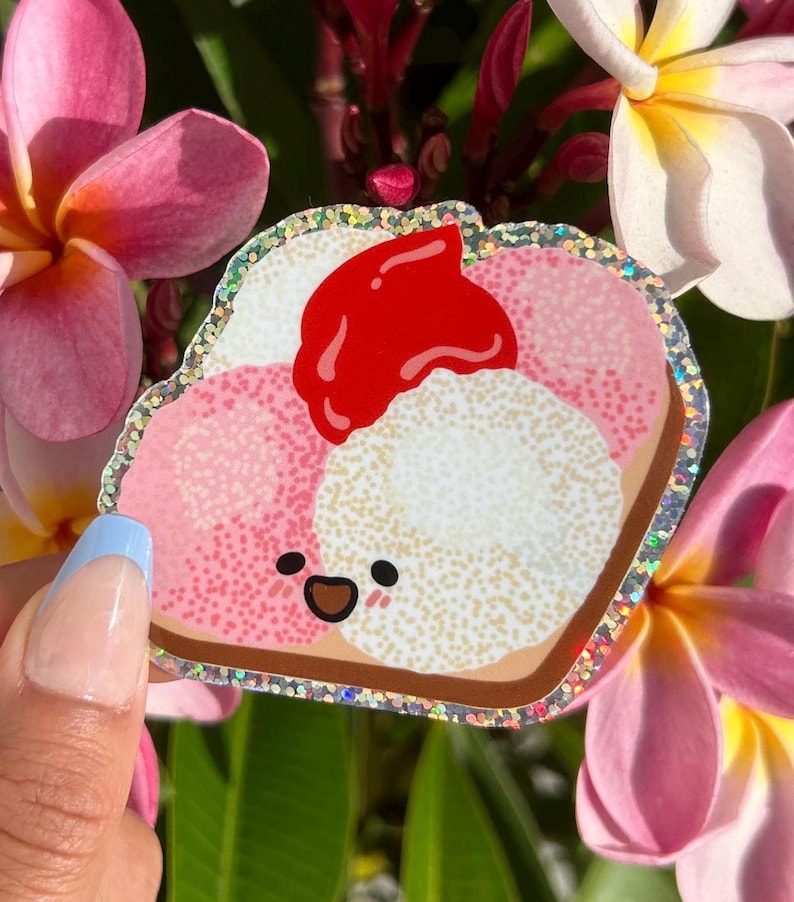 Peut inclure: Un sandwich de dessin anim&eacute; rose, blanc et rouge avec un visage heureux. Le sandwich a une bordure scintillante.
