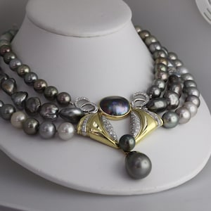 Item16. Black Tahitian pearl gold and platinum  necklace.