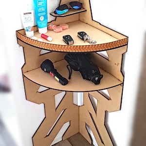 May include: A wooden corner shelf with three shelves. The top shelf has two pairs of sunglasses, the middle shelf has two bottles of sunscreen, a lip balm, and a small container of makeup, and the bottom shelf has a flashlight, an umbrella, and two car keys.