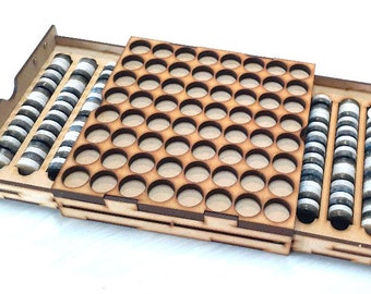 May include: A wooden storage box with a sliding drawer. The drawer is open and reveals rows of small, round containers. The box is made of light brown wood and has a natural finish.