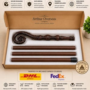 May include: A brown wooden staff with a hand-carved, ornate, spiraled top section, disassembled into three straight segments and one decorative head piece, presented inside a rectangular cardboard box with white foam padding inserts.