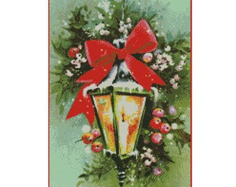 May include: Cross stitch chart pattern for a Christmas lamp with a red bow, green holly, and red berries. The chart is 150 stitches wide by 215 stitches high, and measures approximately 10 3/4 inches by 15 1/2 inches.
