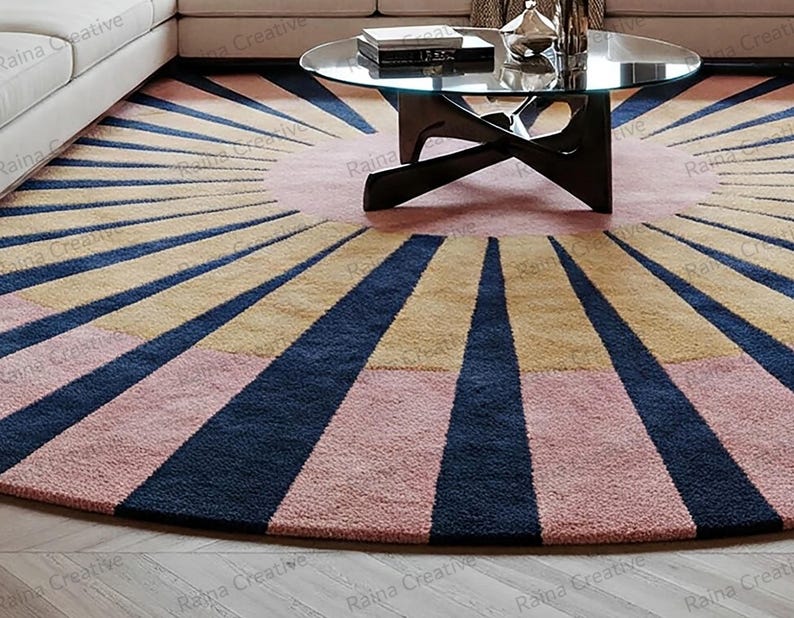 Round hand-tufted rug, 9 ft, sunburst navy rays on pink and mustard wool blend, modern boho living room carpet.