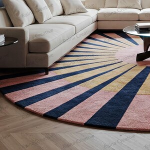Round sunburst rug in navy, mustard, and pink; hand-tufted wool blend, 9ft, modern boho living room carpet.