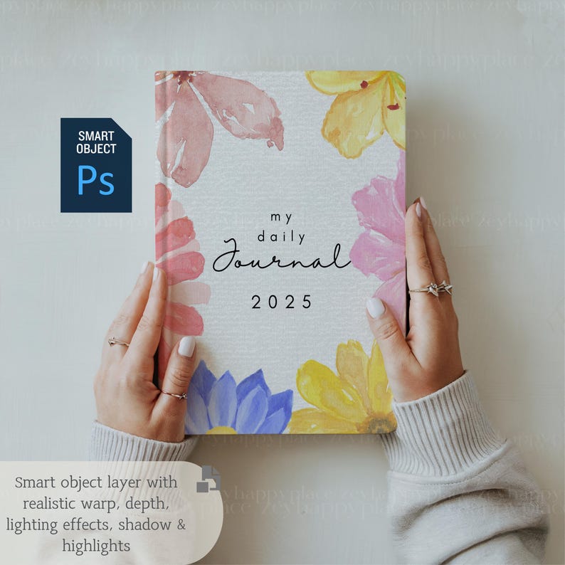 May include: A white journal with a watercolor floral design. The journal has the text "my daily journal 2025" on the front cover.