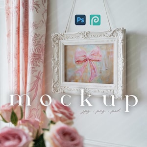 May include: A white ornate picture frame with a painting of a pink bow hanging on a white wall. The word "mockup" is displayed in large white letters below the frame. Pink roses and a pink floral curtain are in the foreground.