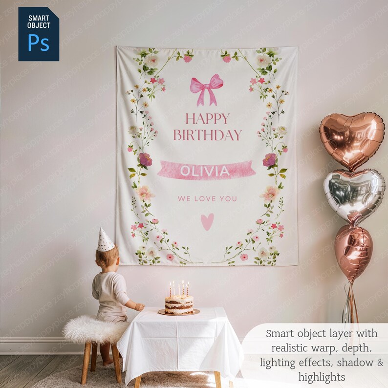 May include: A white birthday banner with floral and pink bow accents. The banner reads "HAPPY BIRTHDAY OLIVIA WE LOVE YOU". Three heart-shaped balloons in rose gold and silver are to the right. A small cake with candles sits on a table.