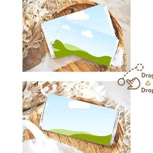 May include: Two blank printable gift tags featuring a blue sky, white clouds, and green grass design. The tags are displayed on a wooden surface with a white fabric background.
