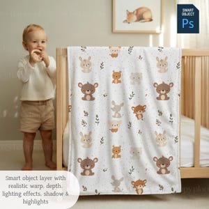 May include: A white baby blanket featuring a repeating pattern of woodland creatures, such as bears, rabbits, and foxes. The blanket is draped over a wooden cot. The blanket has a soft, dotted background with small leaf accents.