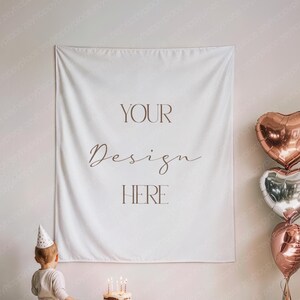 May include: A white wall tapestry with the words "YOUR Design HERE" in brown script. The tapestry is hanging on a wall. A child in a party hat stands in front of a birthday cake with lit candles. Heart-shaped balloons are to the right.