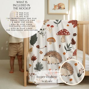 May include: A cream-coloured baby blanket with a whimsical forest design featuring mushrooms, leaves, and a hedgehog. The blanket is draped over a wooden cot. The image includes text: "WHAT IS INCLUDED IN THE MOCKUP" and "hyper-realistic texture."