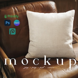 May include: A square, off-white textured pillow rests on a brown leather armchair. The word "mockup" is displayed in large white letters below the pillow. The image also includes logos for Printify, Photoshop, and Canva.