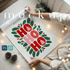 May include: A Christmas-themed poster featuring the words "HO HO HO" in red and pink, framed by green foliage and red berries. The poster also displays a Christmas tree and the text "ABSTRACT COLLECTION".