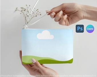 May include: A light blue zippered pouch with a white cloud and green hills design. The pouch is held by two hands and has a white zipper pull with a dried flower attached.