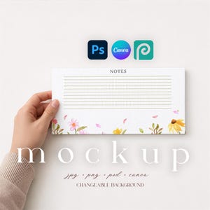 May include: A white notepad with the word "NOTES" at the top and lined pages. The bottom of the notepad features watercolour floral designs in pink, yellow, and green. The word "mockup" is displayed in large letters below the notepad.