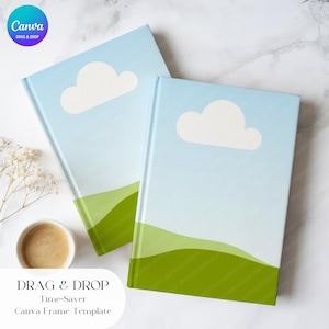 May include: Two hardcover notebooks with a sky-blue cover featuring a white cloud and green hills. The notebooks have the text "DRAG & DROP Time-Saver Canva Frame Template". A cup of coffee and flowers are in the background.