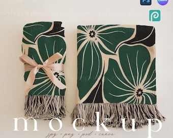 May include: Two green and black throw blankets with a floral pattern and fringe. The blankets are folded and displayed on a white surface. The text "mockup" is written below the blankets.